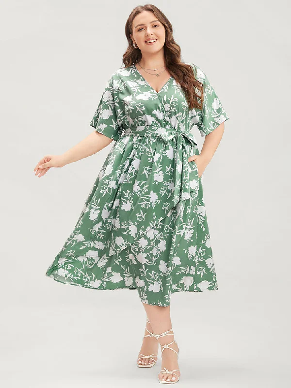 Plus size dresses featuring neutral tones pair easily -Plus size dresses with bold patterns for a fun look -Floral Dolman Sleeve Pocket Belted Wrap Asymmetrical Flutter Dress